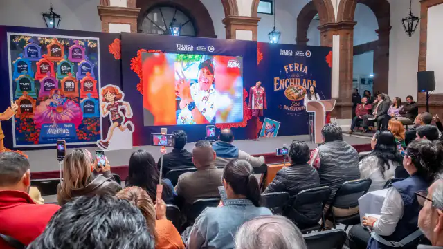 Personas degustando enchiladas en un puesto de feria en Toluca